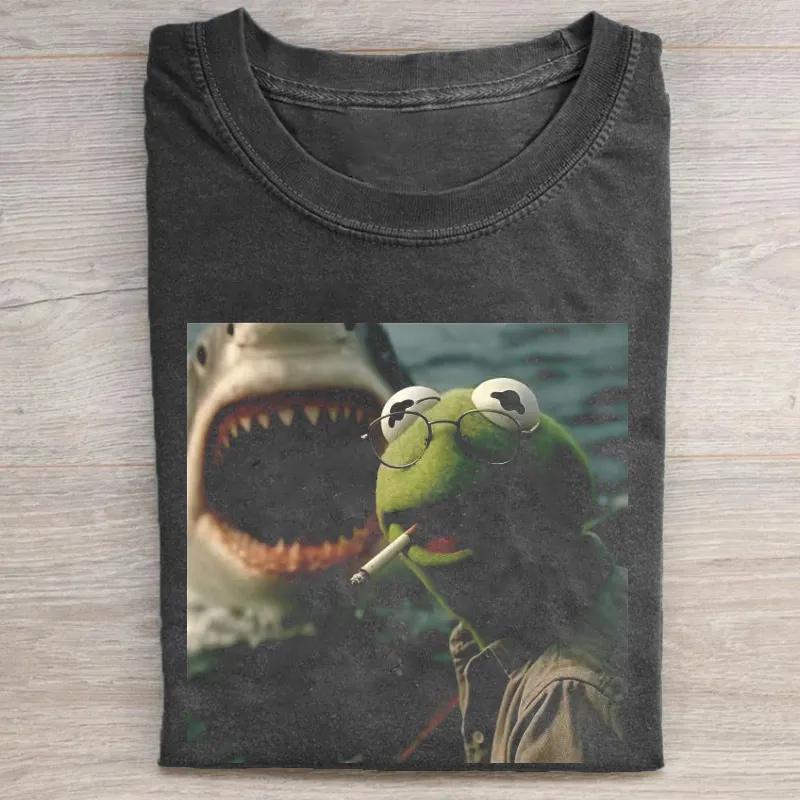 for Kermit Jaws ShirtCharcoal gray washed t-shirt featuring a graphic print of Kermit the Frog wearing round glasses and smoking a cigarette, with a shark's open mouth visible in the blurred background.