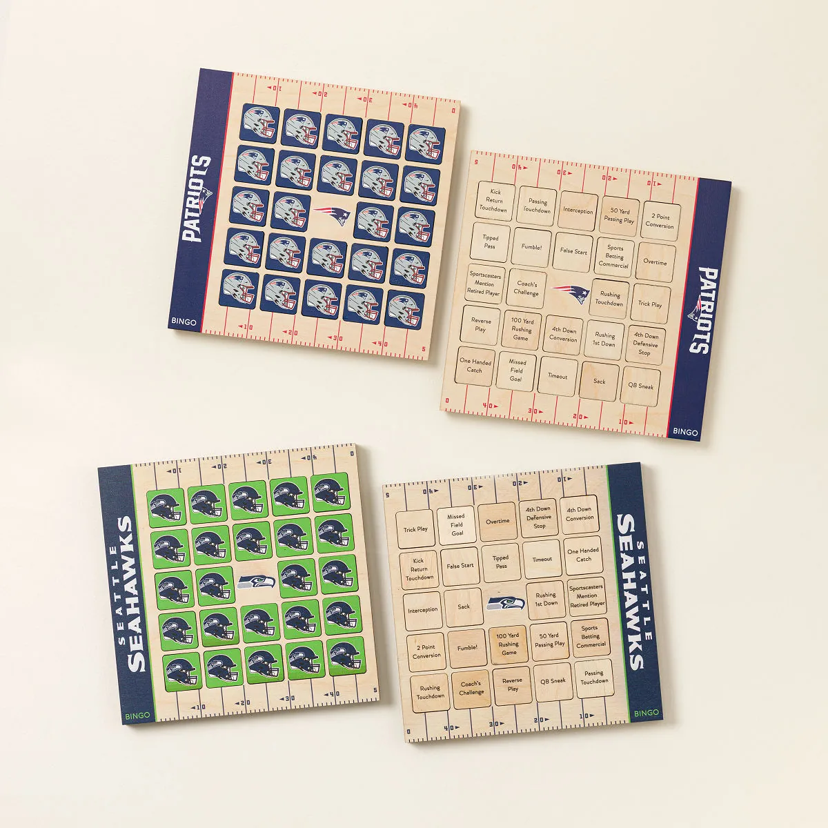 Four NFL-themed bingo cards featuring the New England Patriots and Seattle Seahawks, with team helmet logos and football-related squares like "Touchdown," "Missed Field Goal," and "Coach's Challenge" replacing traditional bingo numbers.