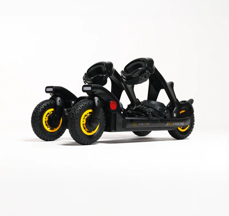 Black electric skis with dual yellow-rimmed wheels and handlebar controls, designed for standing upright snow and pavement riding.