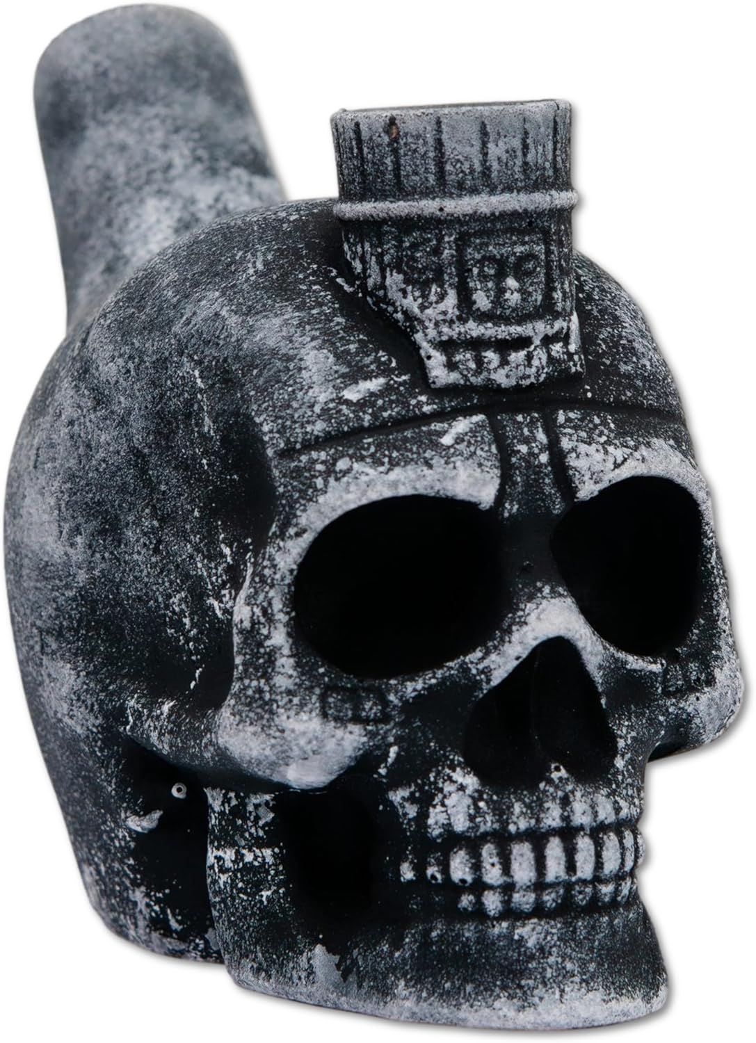 A gray stone skull-shaped musical instrument with large hollow eye sockets and an ornamental headdress on top, designed to produce eerie whistling sounds when air is blown through it.